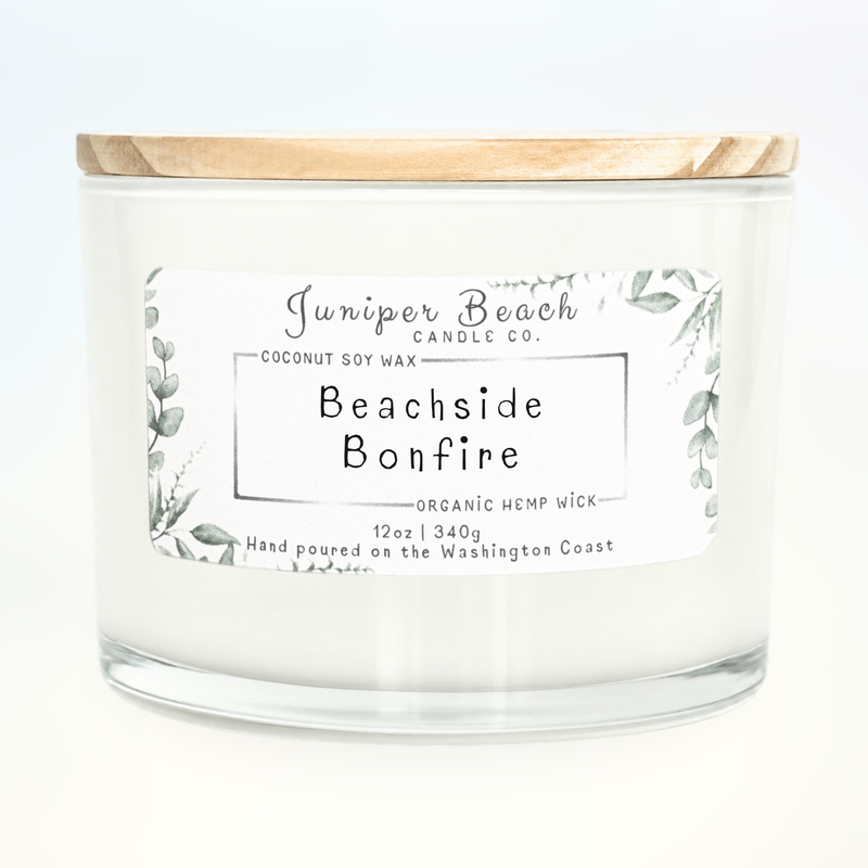 Beachside Bonfire 12 oz candle in a white glass jar with a natural pine lid