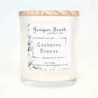 Cashmere Breeze 11 oz candle in a white glass jar with a natural pine lid