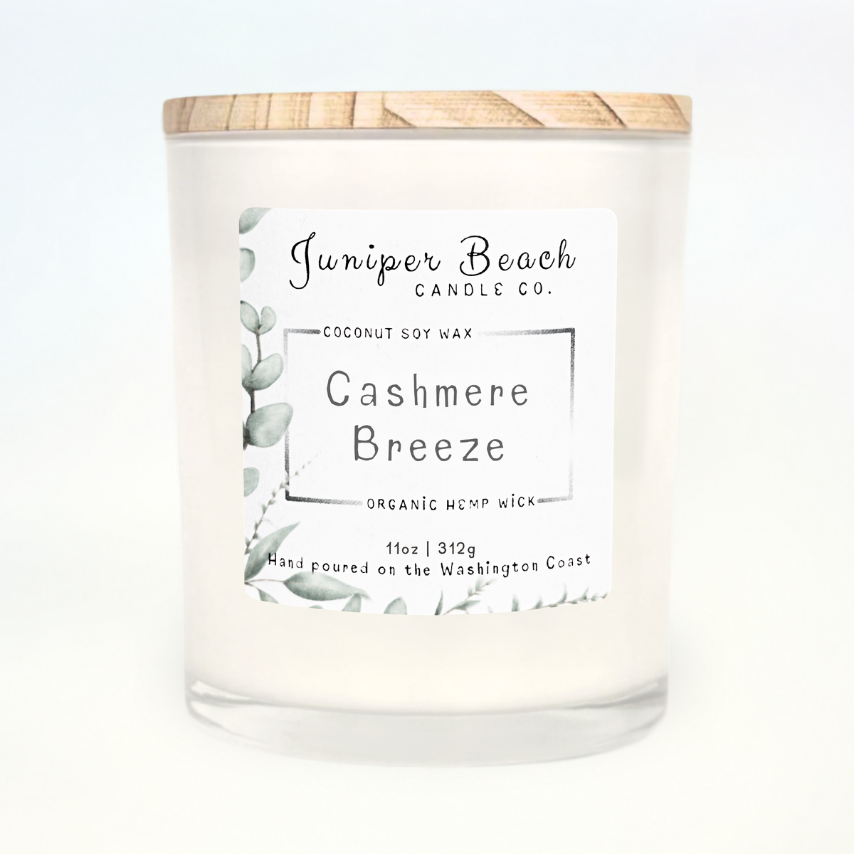 Cashmere Breeze 11 oz candle in a white glass jar with a natural pine lid