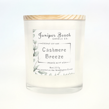 Cashmere Breeze 8 oz candle in a white glass jar with a natural pine lid