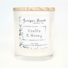 Vanilla & Honey 11 oz candle in a white glass jar with a natural pine lid