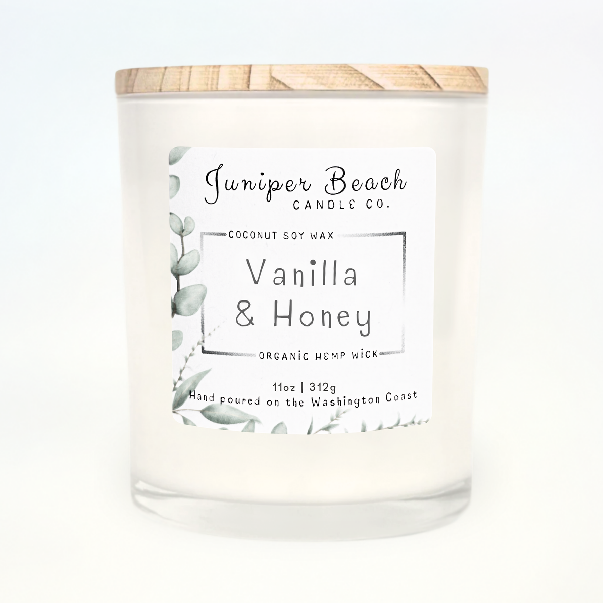 Vanilla & Honey 11 oz candle in a white glass jar with a natural pine lid
