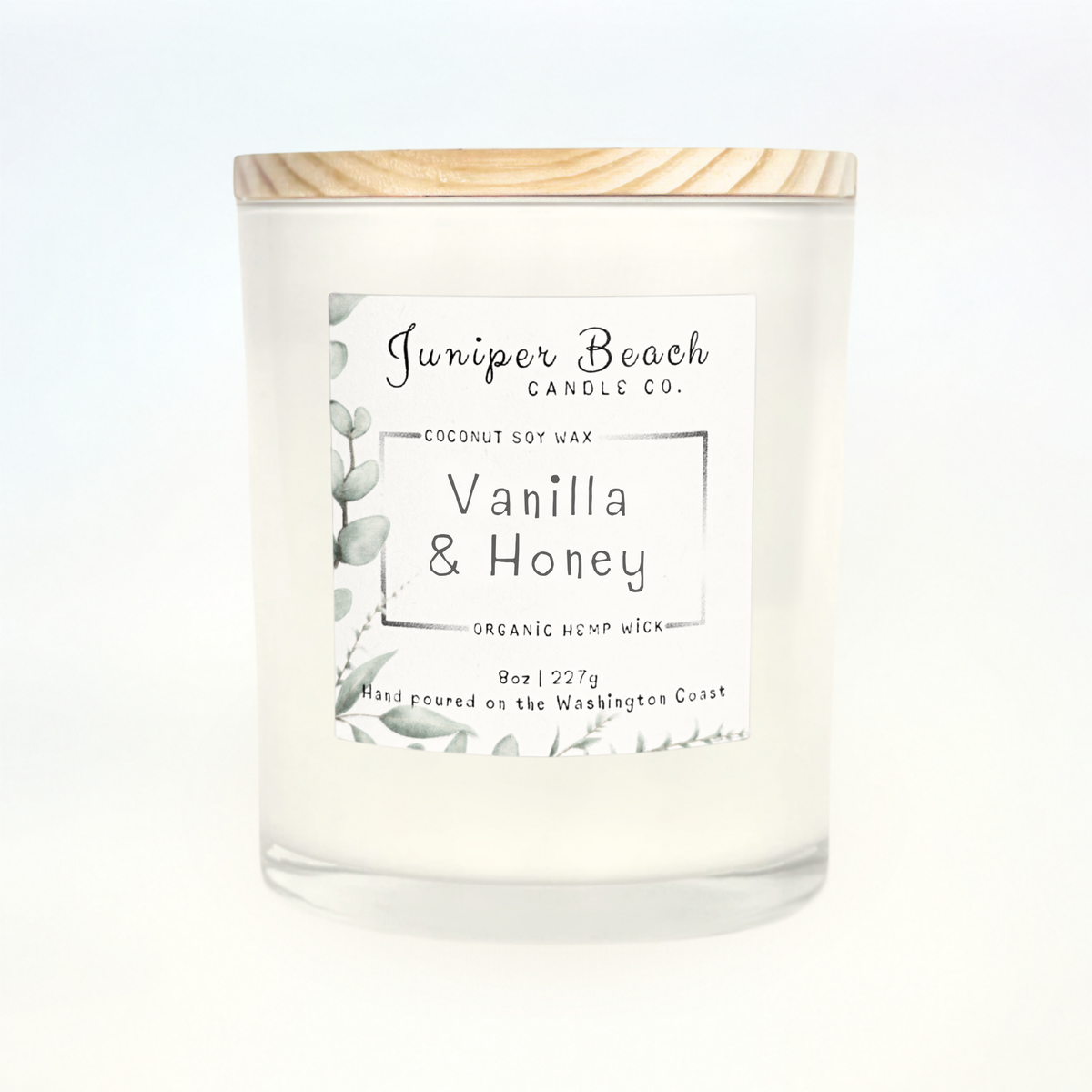 Vanilla & Honey 8 oz candle in a white glass jar with a natural pine lid
