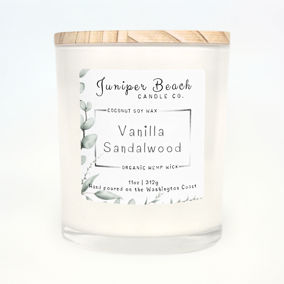 Vanilla Sandalwood 11 oz candle in a white glass jar with a natural pine lid