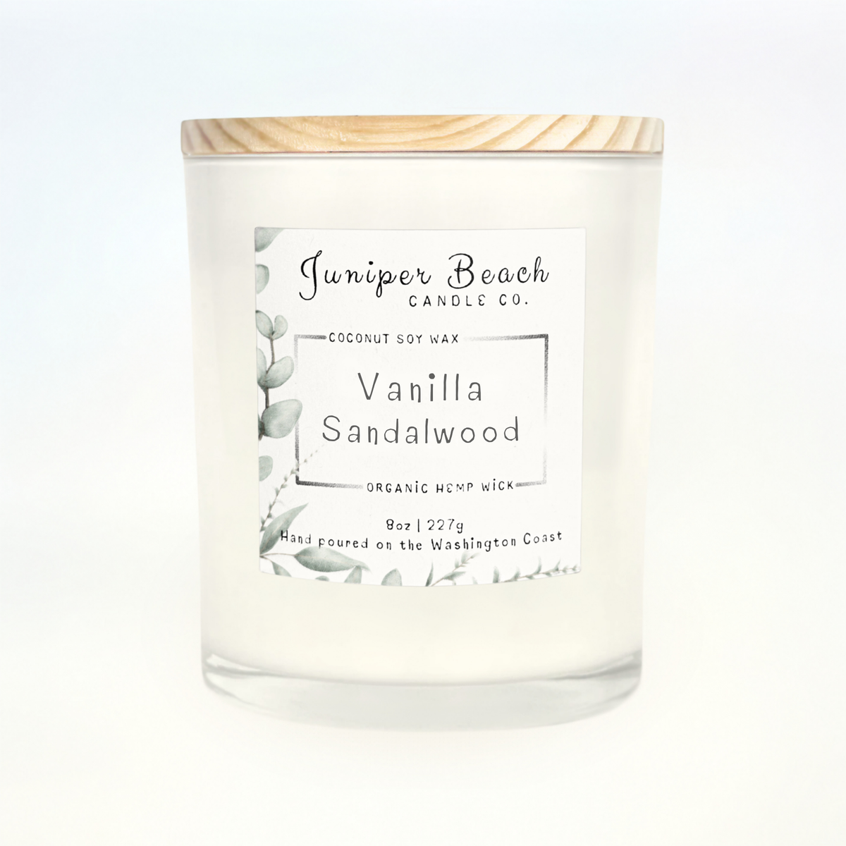 Vanilla Sandalwood 8 oz candle in a white glass jar with a natural pine lid