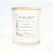 Vanilla Sandalwood 8 oz candle in a white glass jar with a natural pine lid