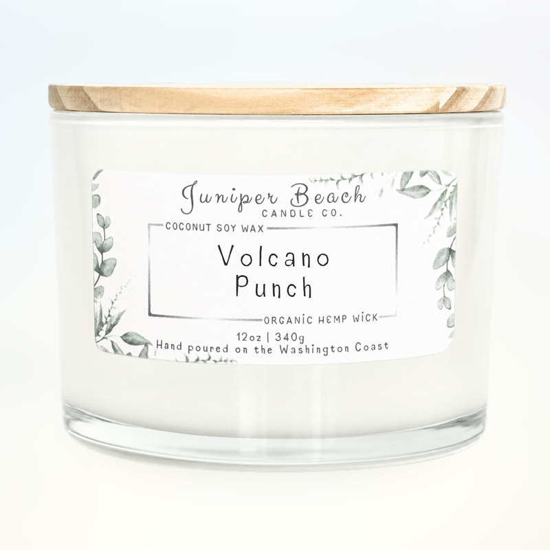 Volcano Punch 12 oz candle in a white glass jar with a natural pine lid