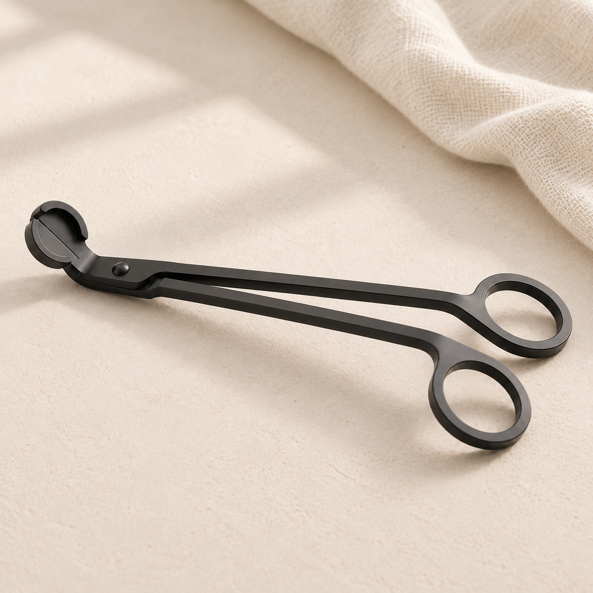 Black candle wick trimmer with loop handle and angled cutting blade