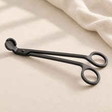Black candle wick trimmer with loop handle and angled cutting blade